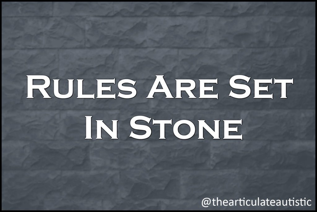 White text on grey stone surface that reads, "Rules Are Set In Stone".
