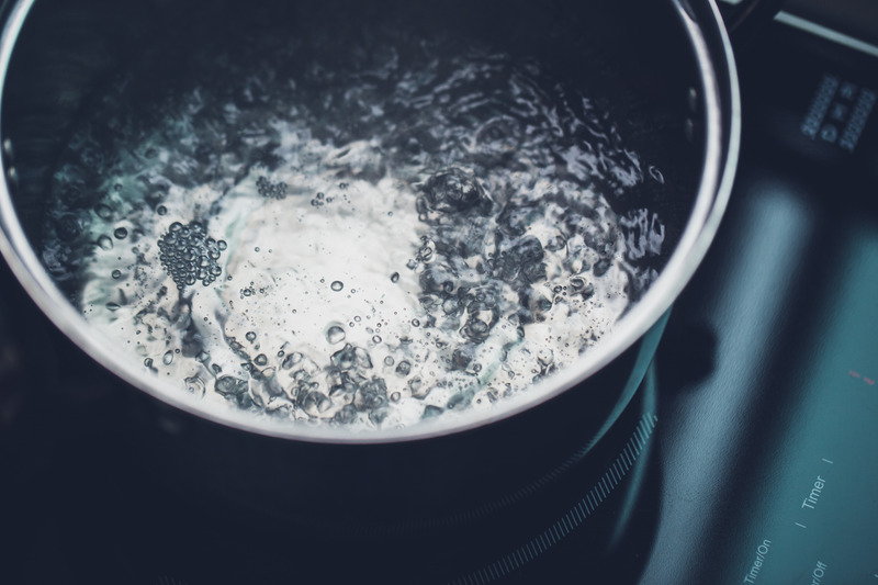 A pot of boiling water on the stove