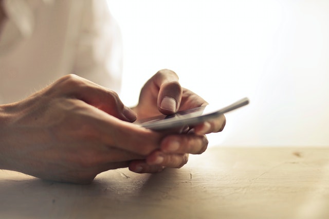 Hands holding a smartphone.