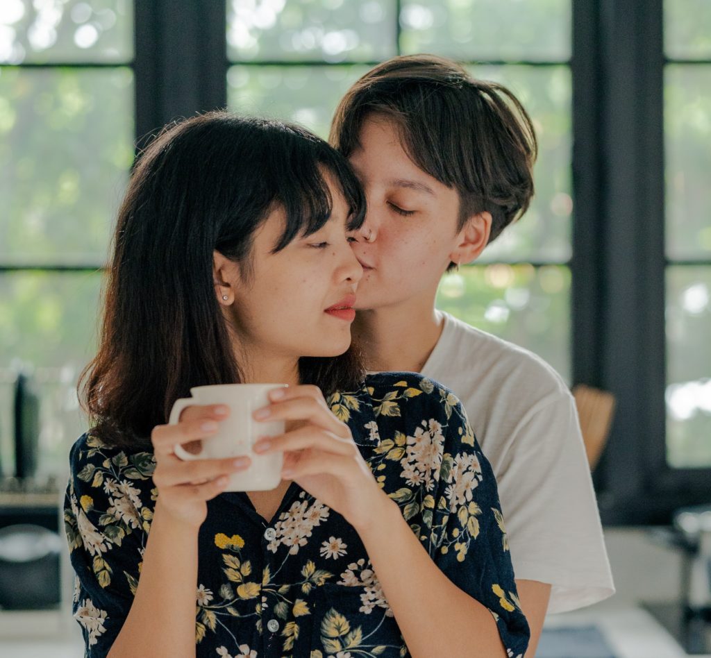 Attractive, young Asian couple embracing. 