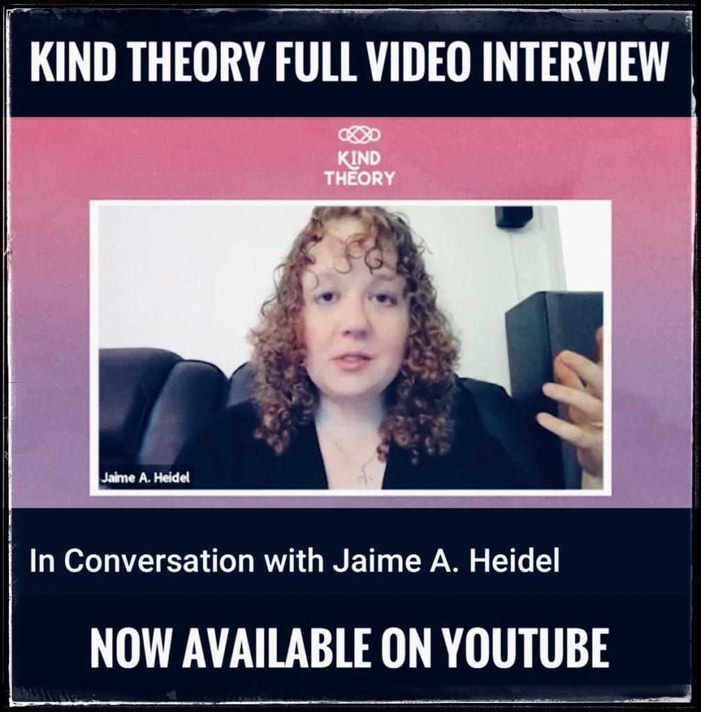 Jaime, a curly-haired, light-skinned woman wearing a black cardigan speaks animatedly at the camera. 