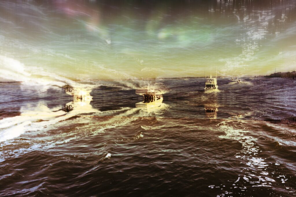 Image of ships on the ocean during an emerging storm. 